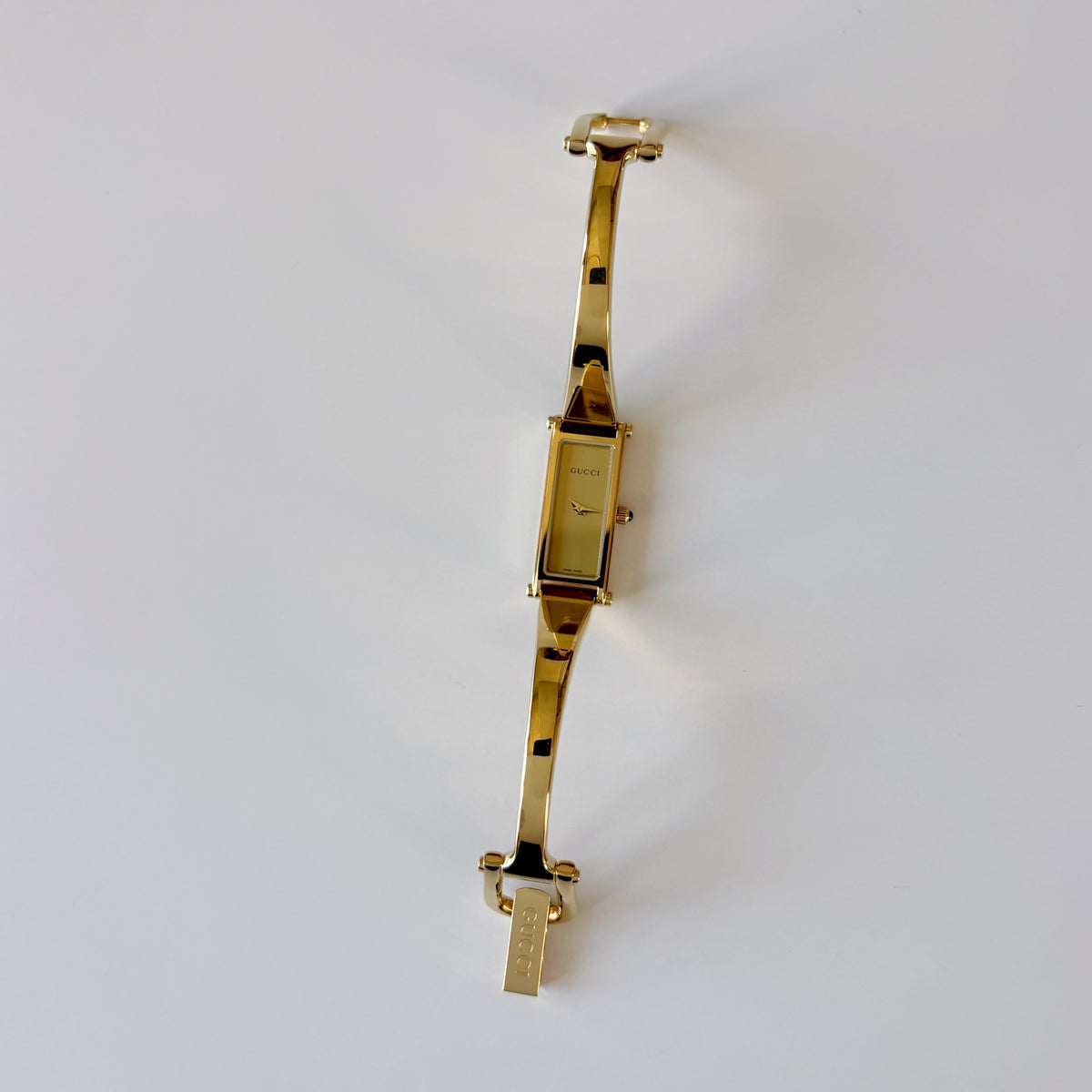 Gucci 1990s Rectangular Gold Dial Gold-Plated Watch