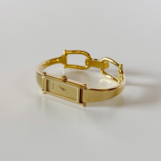 Gucci 1990s Rectangular Gold Dial Gold Plated Bangle Watch (Small)