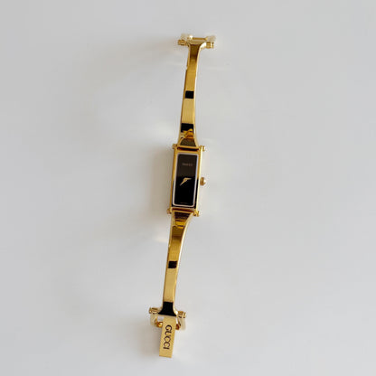 Gucci 1990s Black Rectangular Dial Gold Plated Bangle Watch