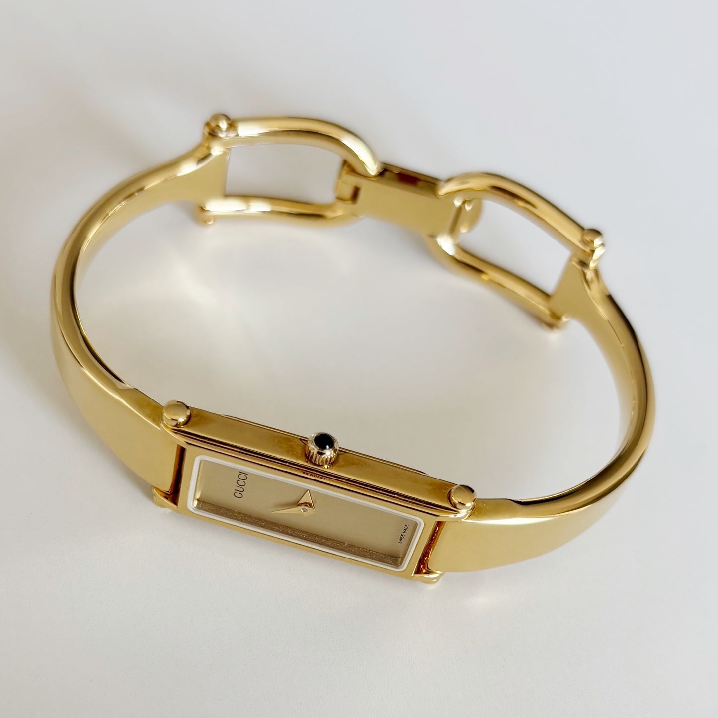 Gucci 1990s Rectangular Gold Dial Gold Plated Bangle Watch
