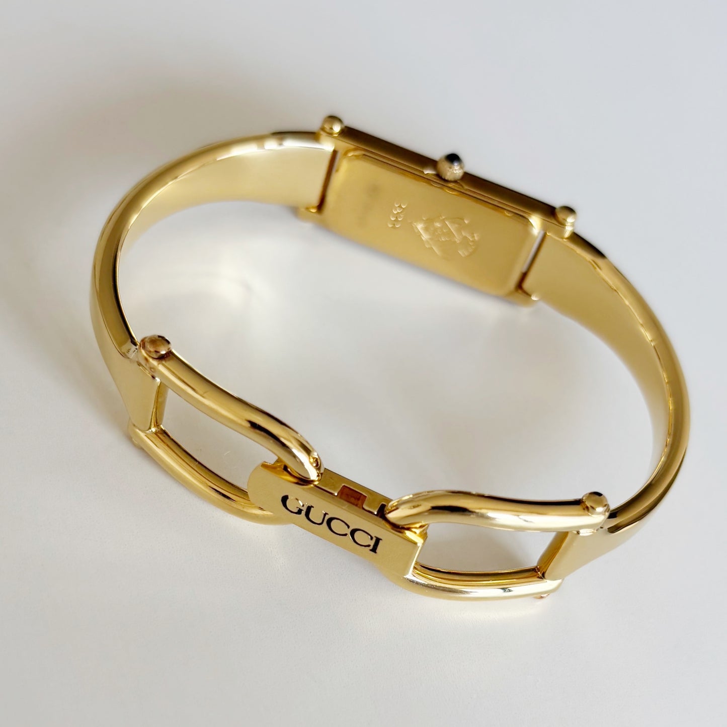 Gucci 1990s Rectangular Gold Dial Gold Plated Bangle Watch