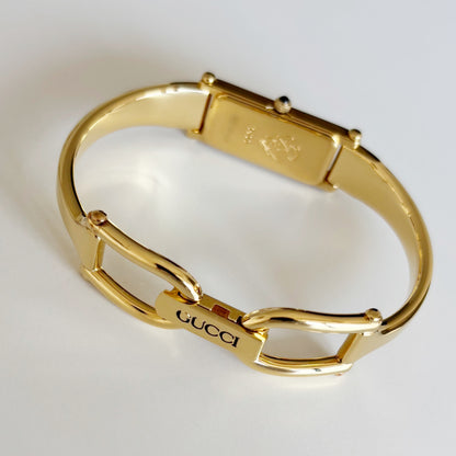 Gucci 1990s Rectangular Gold Dial Gold Plated Bangle Watch