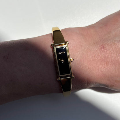 Gucci 1990s Black Rectangular Dial Gold Plated Bangle Watch