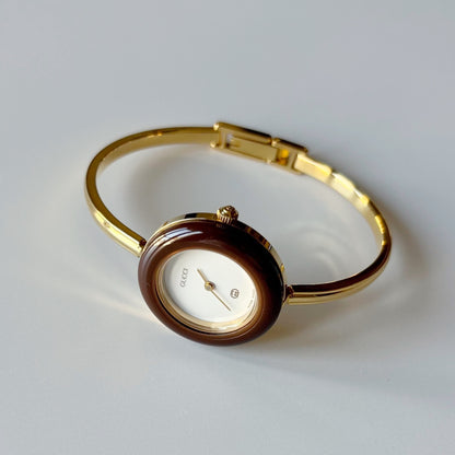 Gucci 1990s Interchangeable Bezel Gold Plated Bangle Watch with 12 bezels, case