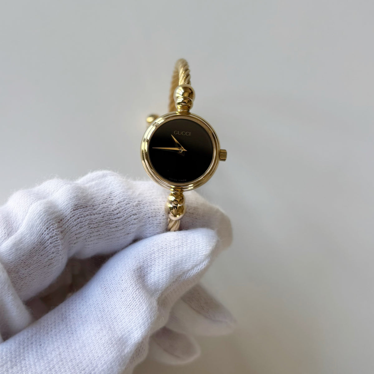 Gucci 1990s Black Round Dial Cable Gold-Plated Bangle Watch