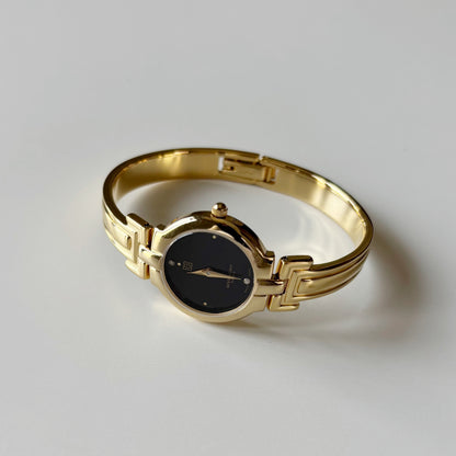 Givenchy 1990s Black Round Dial Gold Plated Bangle Watch
