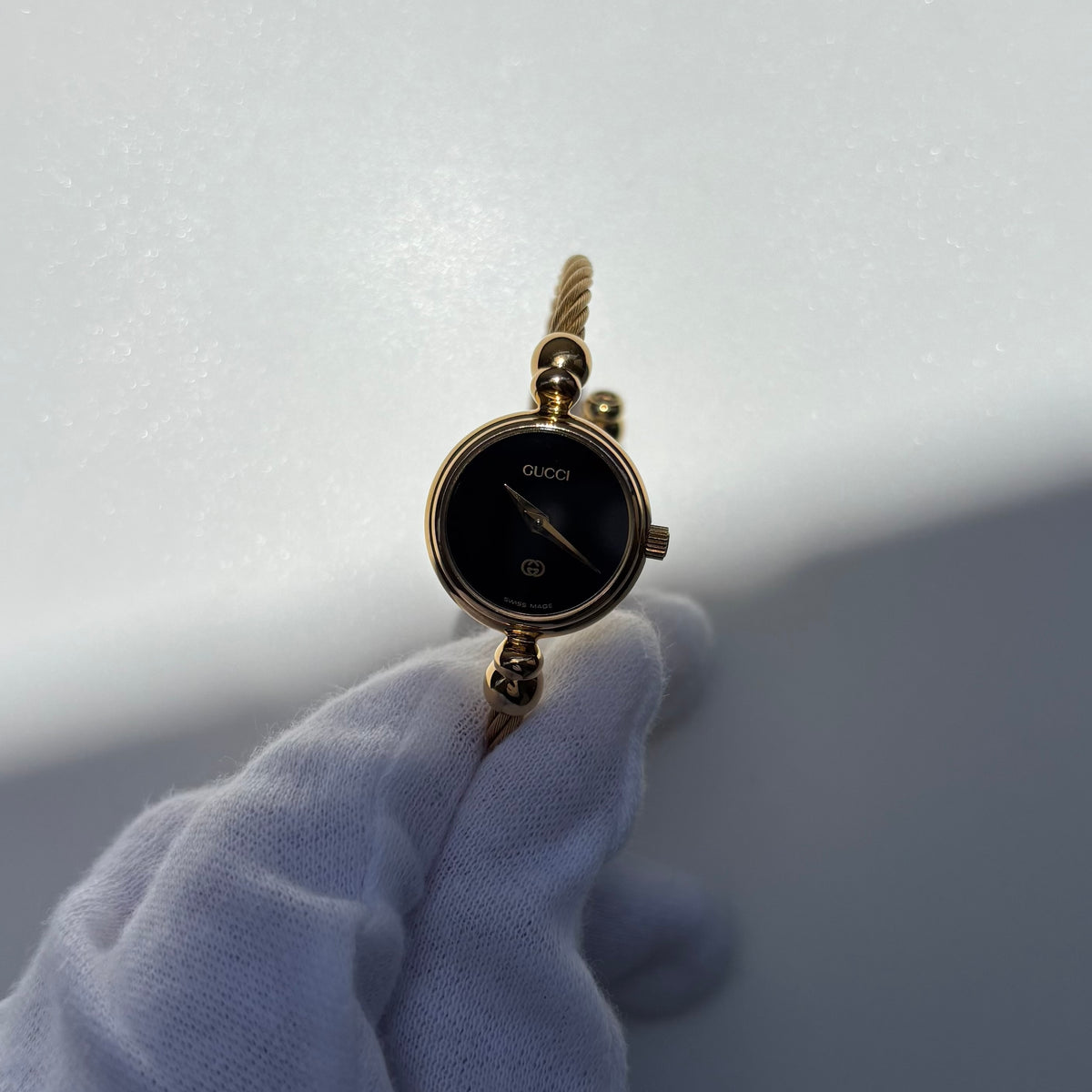 Gucci 1990s Black Round Dial Cable Gold Plated Bangle Watch