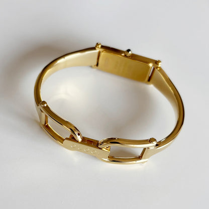 Gucci 1990s Rectangular Gold Dial Gold Plated Bangle Watch