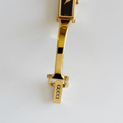Gucci 1990s Black Rectangular Dial Gold Plated Bangle Watch