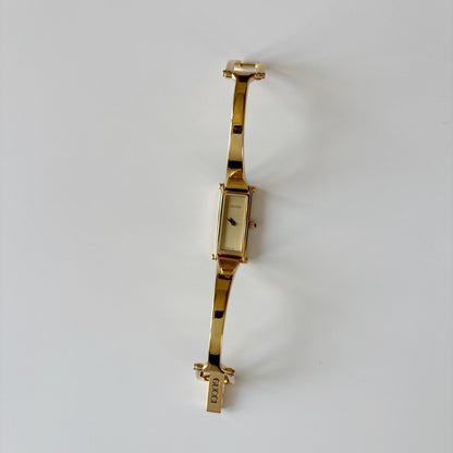 Gucci 1990s Rectangular Gold Dial Gold Plated Bangle Watch