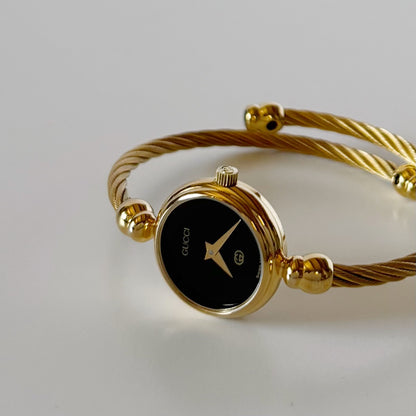 Gucci 1990s Black Round Dial Cable Gold Plated Bangle Watch