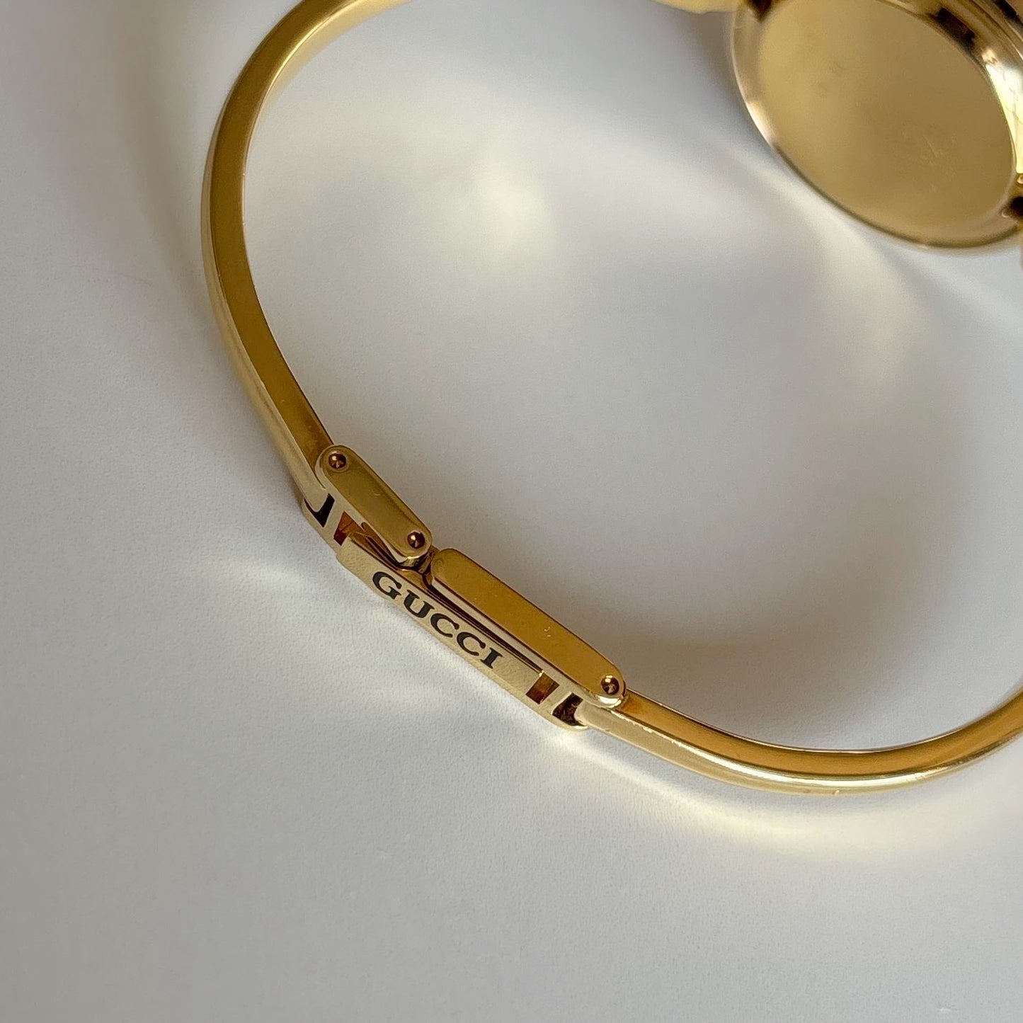 Gucci 1990s Interchangeable Bezel Gold Plated Bangle Watch with 12 bezels, case