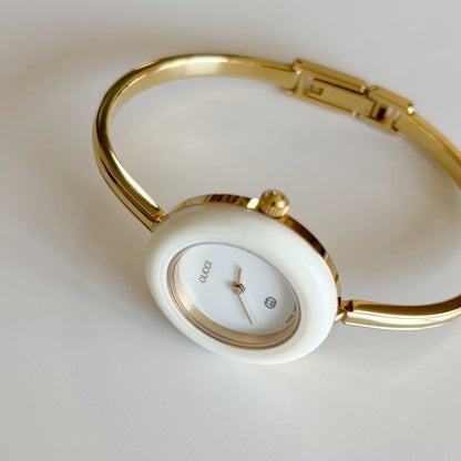 Gucci 1980s Interchangeable Bezel Gold Plated Bangle Watch with 12 bezels, case