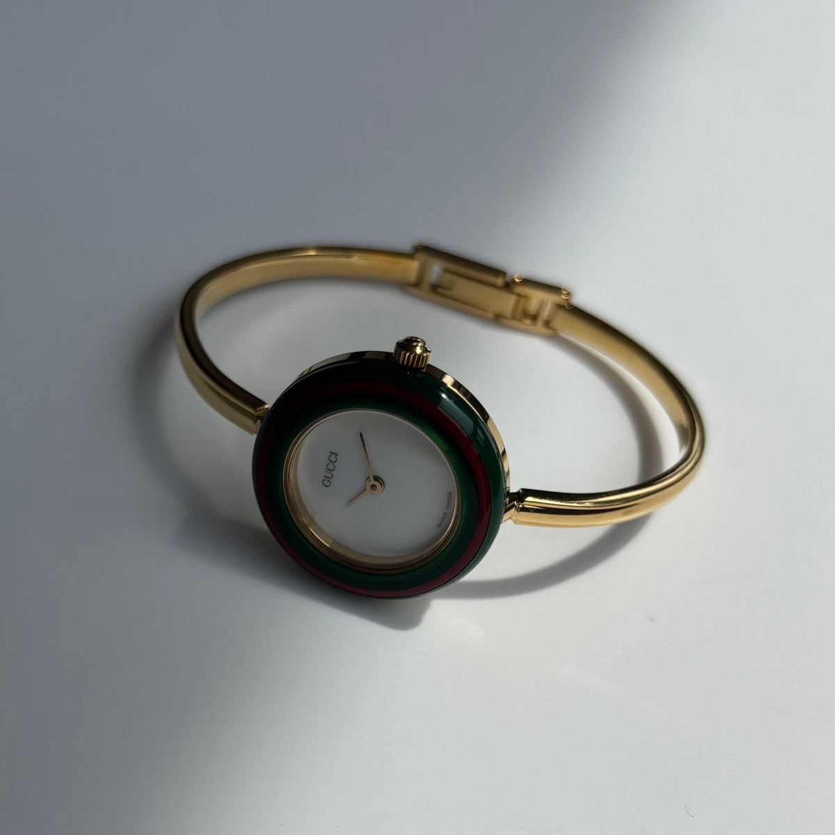 Gucci 1990s Interchangeable Bezel Gold Plated Bangle Watch with 12 bezels, case