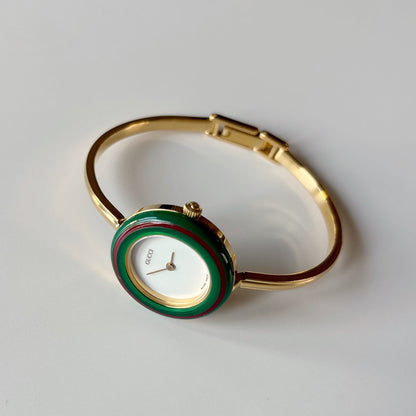 Gucci 1990s Interchangeable Bezel Gold Plated Bangle Watch with 12 bezels, case