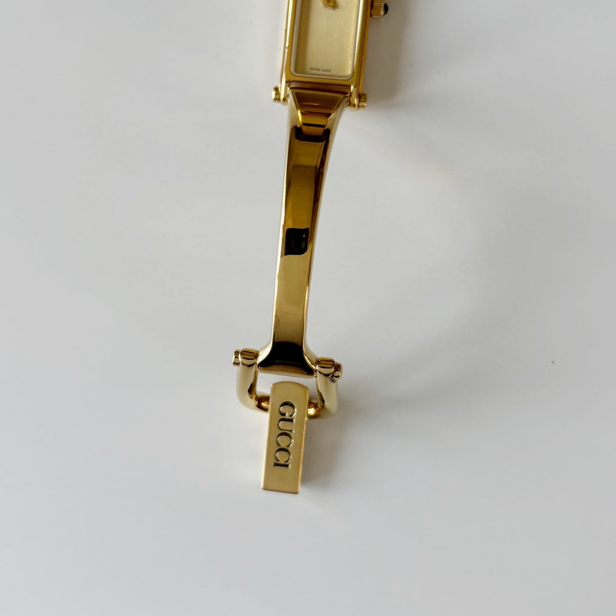 Gucci 1990s Rectangular Gold Dial Gold Plated Bangle Watch