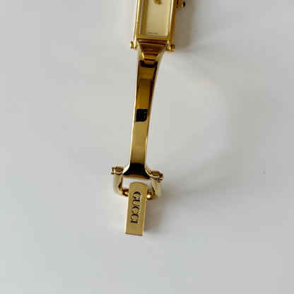 Gucci 1990s Rectangular Gold Dial Gold Plated Bangle Watch