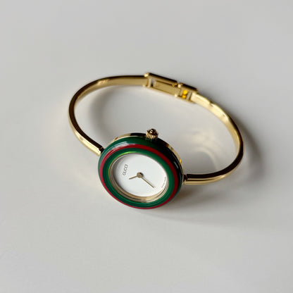 Gucci 1990s Interchangeable Bezel Gold Plated Bangle Watch with 12 bezels, case