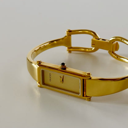 Gucci 1990s Rectangular Gold Dial Gold Plated Bangle Watch