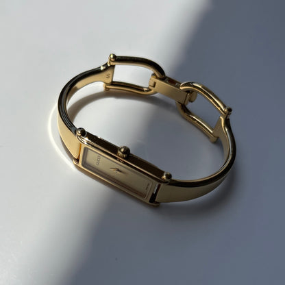 Gucci 1990s Rectangular Gold Dial Gold Plated Bangle Watch (Small)