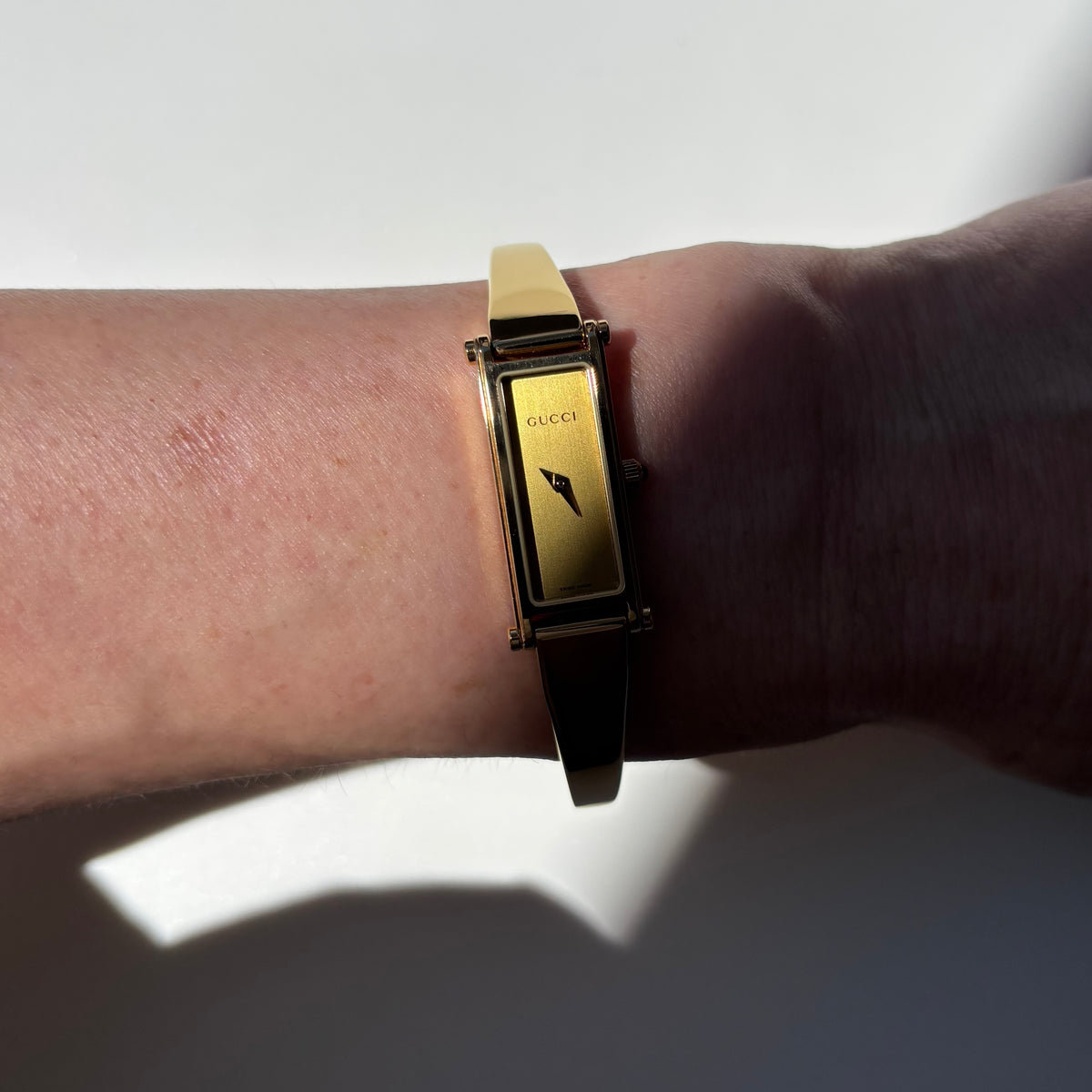 Gucci 1990s Rectangular Gold Dial Gold-Plated Watch