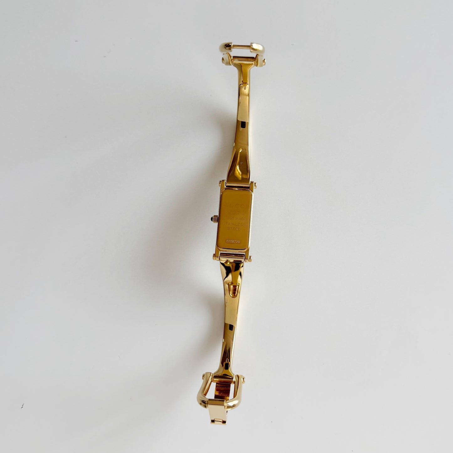 Gucci 1990s Rectangular Gold Dial Gold Plated Bangle Watch