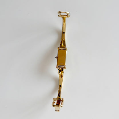 Gucci 1990s Rectangular Gold Dial Gold Plated Bangle Watch