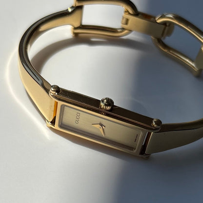 Gucci 1990s Gold Rectangular Dial Gold Plated Bangle Watch