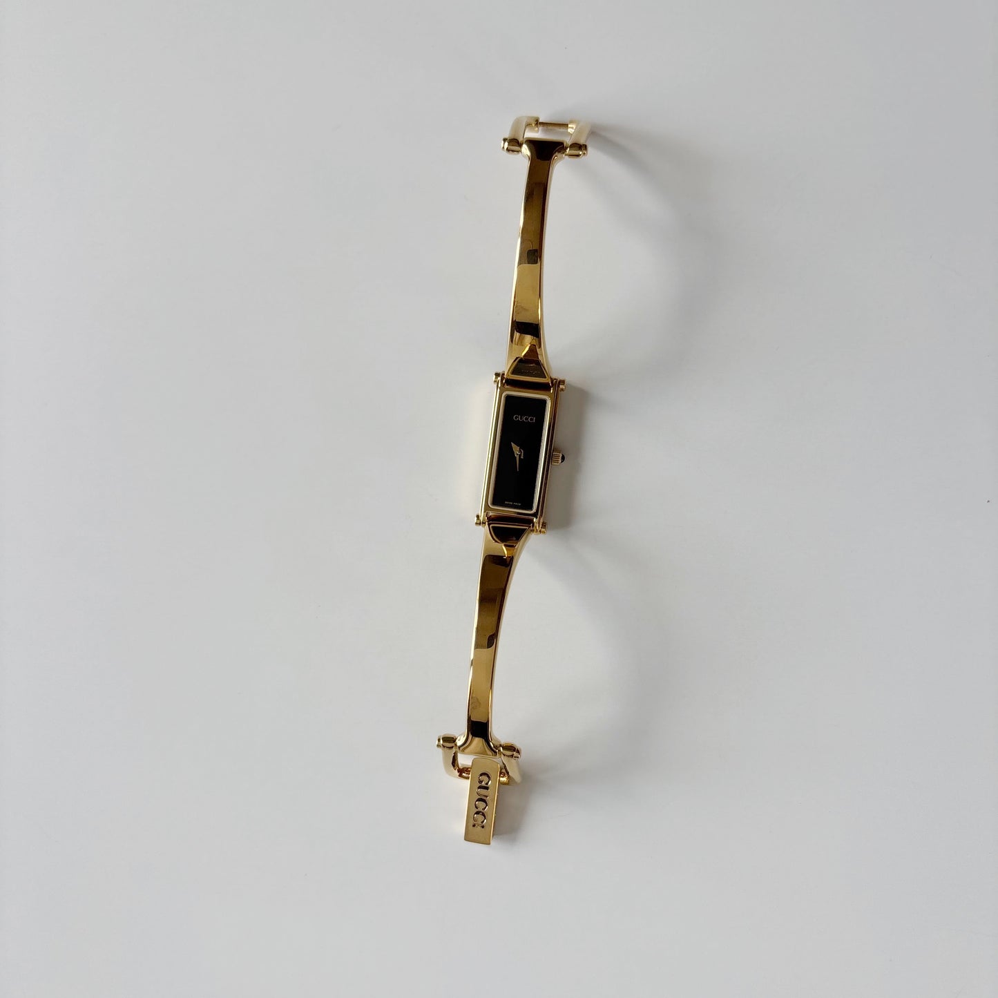 Gucci 1990s Black Rectangular Dial Gold Plated Bangle Watch