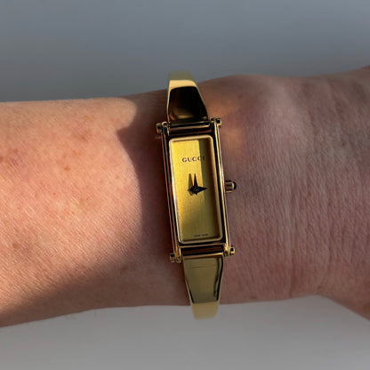 Gucci 1990s Rectangular Gold Dial Gold Plated Bangle Watch