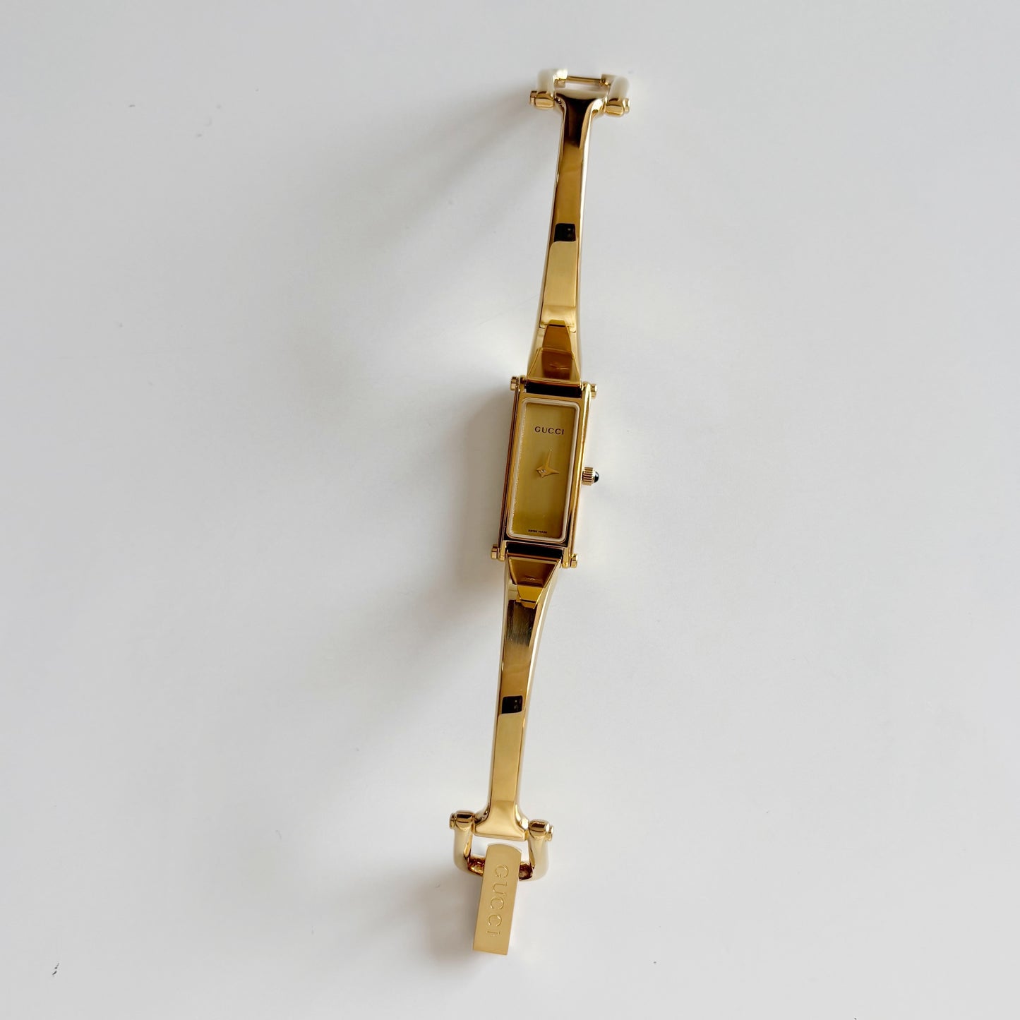 Gucci 1990s Rectangular Gold Dial Gold Plated Bangle Watch