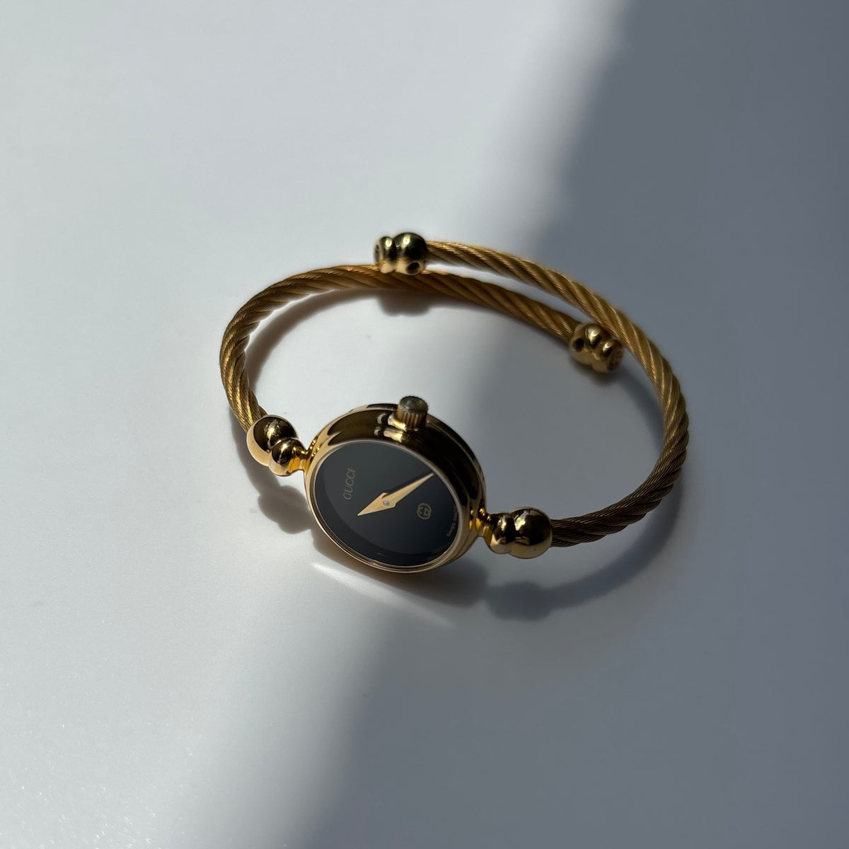 Gucci 1990s Black Round Dial Cable Gold Plated Bangle Watch