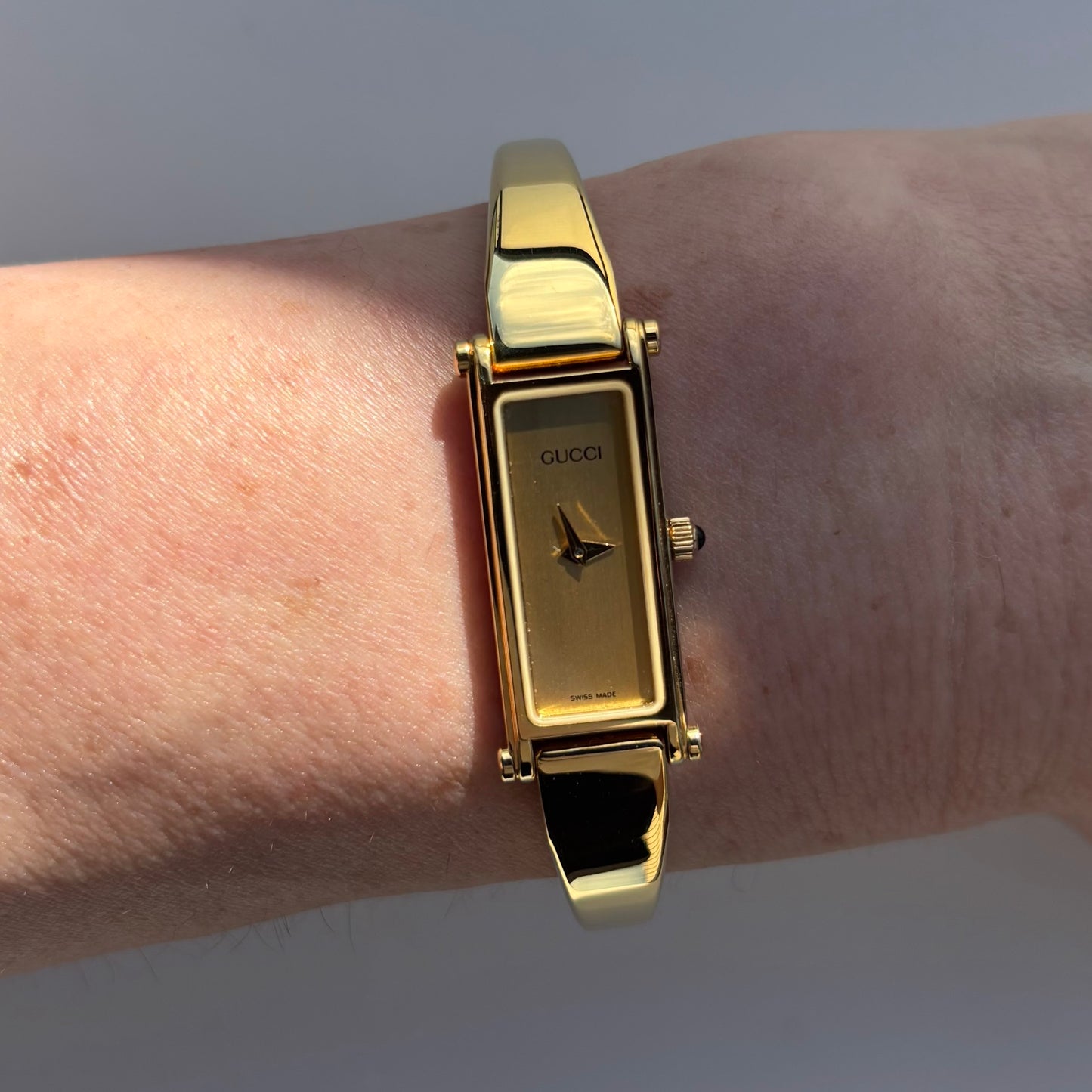 Gucci 1990s Rectangular Gold Dial Gold Plated Bangle Watch