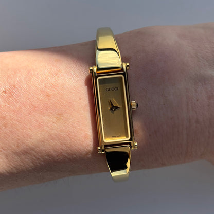Gucci 1990s Rectangular Gold Dial Gold Plated Bangle Watch