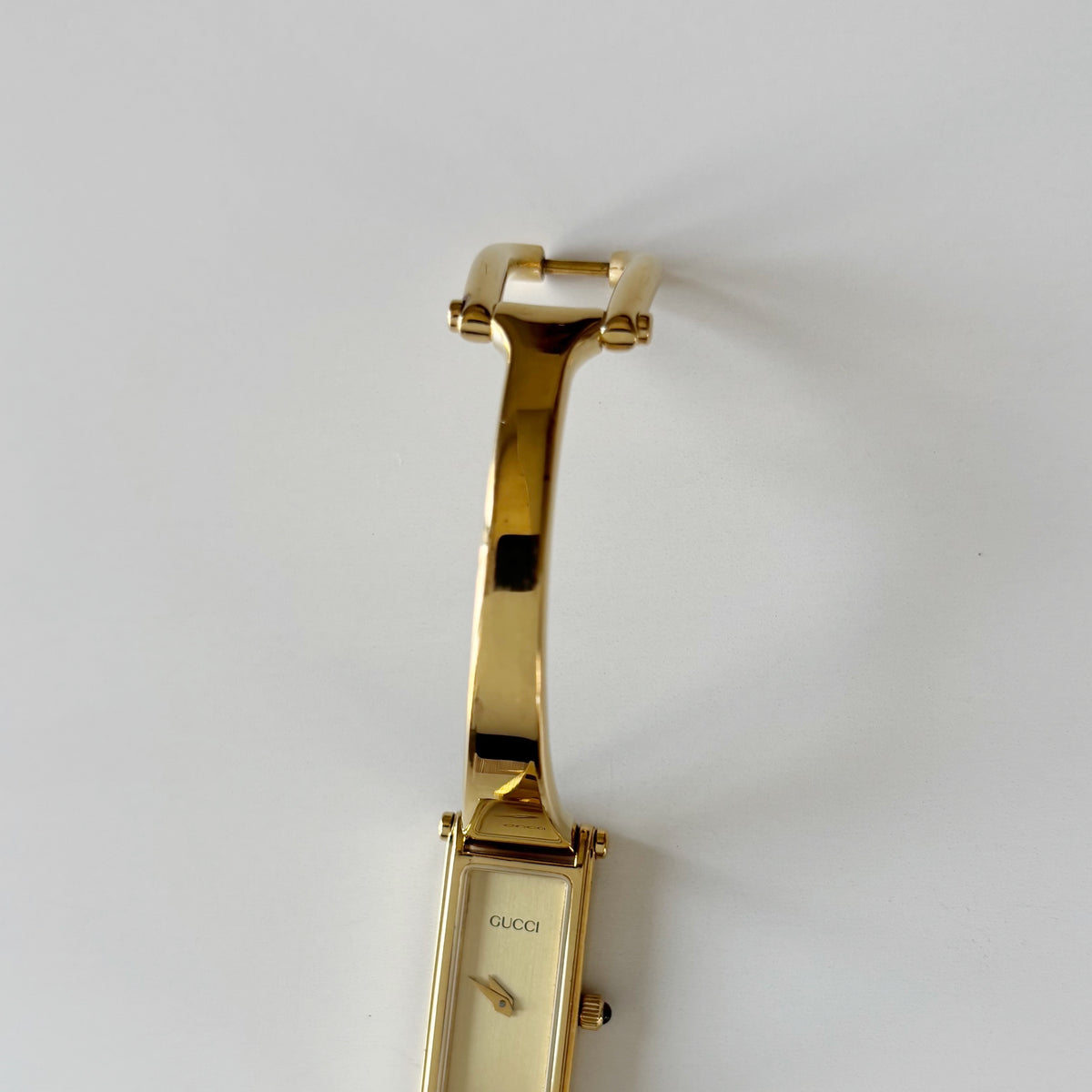 Gucci 1990s Rectangular Gold Dial Gold Plated Bangle Watch