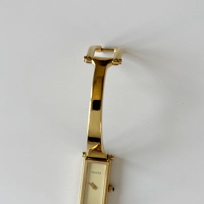Gucci 1990s Rectangular Gold Dial Gold Plated Bangle Watch
