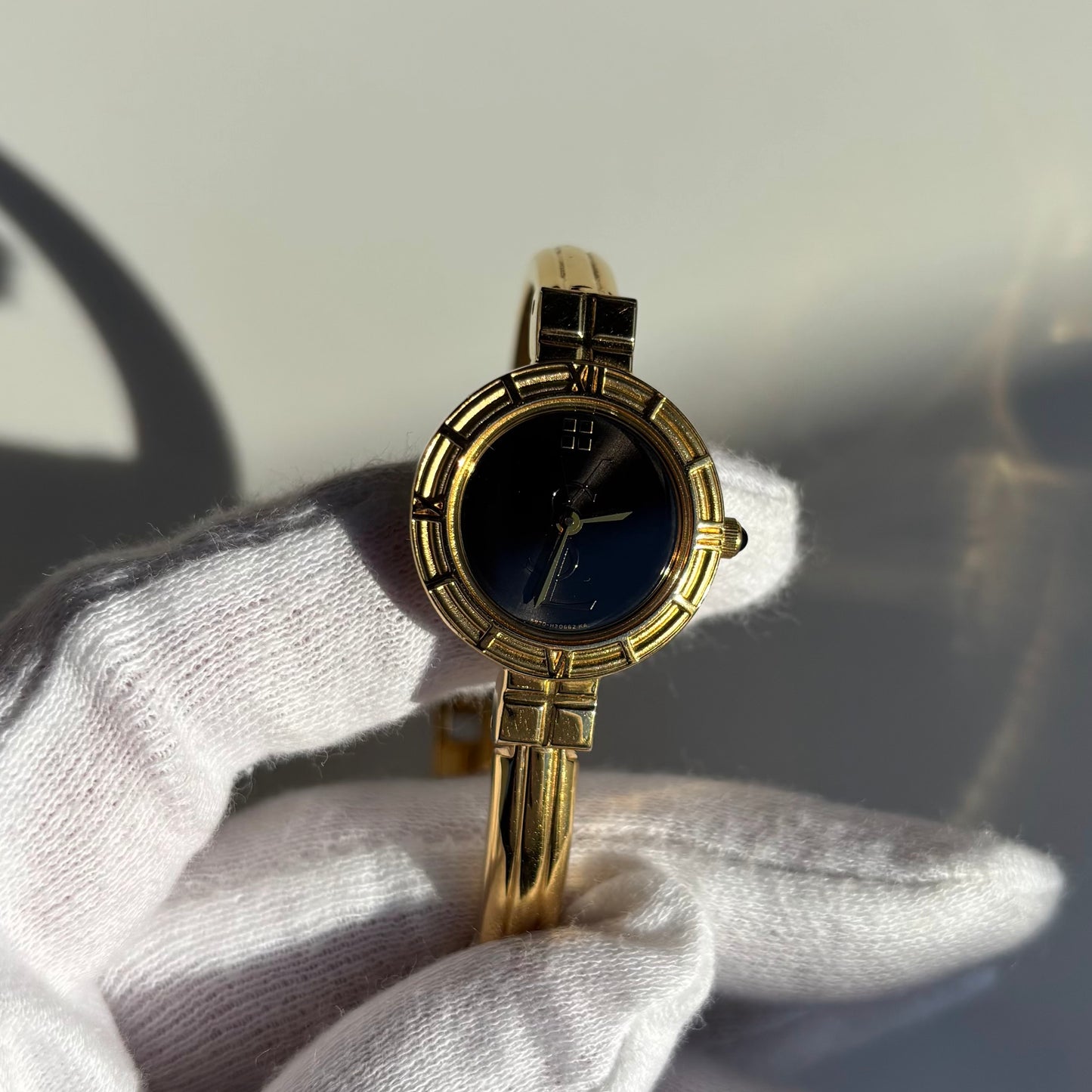 Yves Saint Laurent 1990s Black Round Dial Gold Plated Bangle Watch