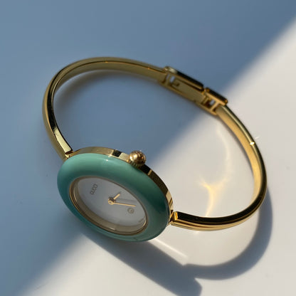 Gucci 1990s Interchangeable Bezel Gold Plated Bangle Watch with 12 bezels, case
