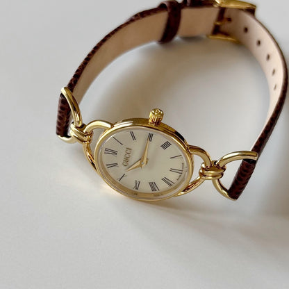 Gucci 1990s Round Cream Dial Horsebit Gold Plated Watch