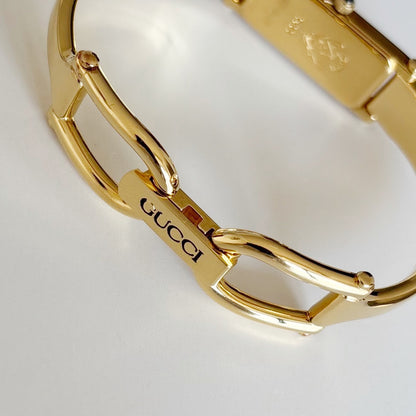 Gucci 1990s Rectangular Gold Dial Gold Plated Bangle Watch
