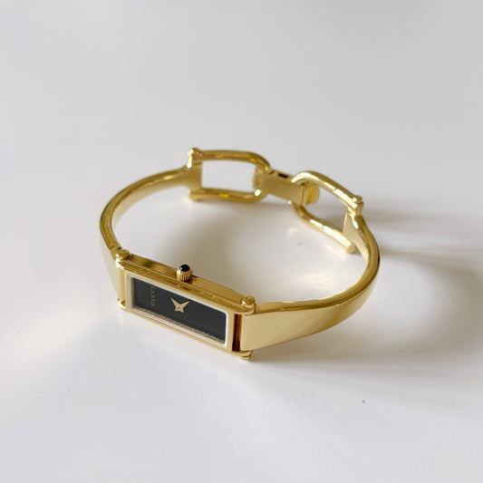 Gucci 1990s Black Dial Rectangular Gold Plated Bangle Watch