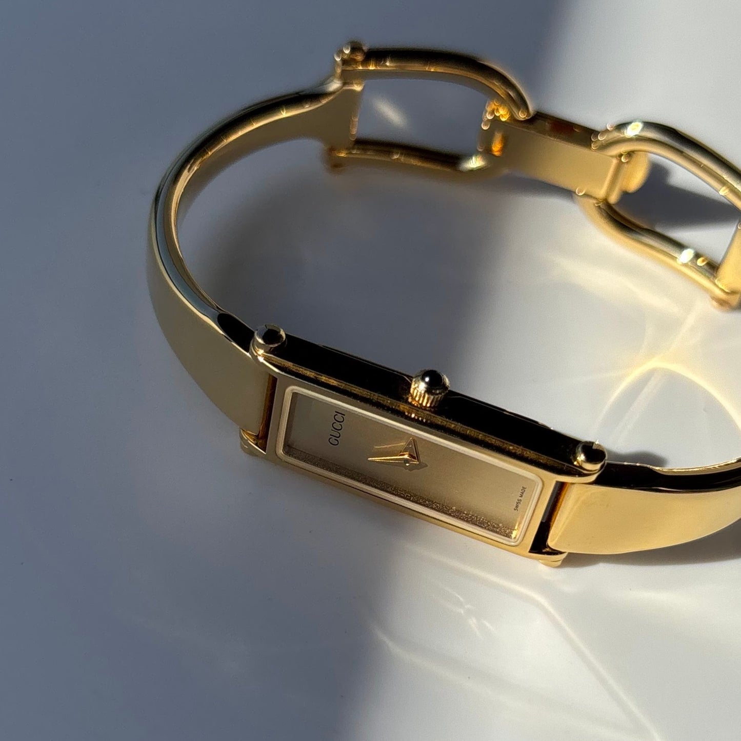 Gucci 1990s Rectangular Gold Dial Gold Plated Bangle Watch