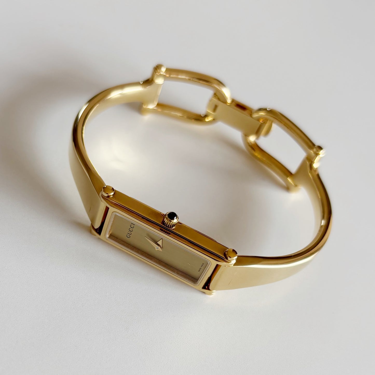 Gucci 1990s Rectangular Gold Dial Gold Plated Bangle Watch