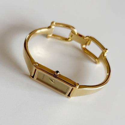 Gucci 1990s Rectangular Gold Dial Gold Plated Bangle Watch
