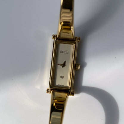 Gucci 1990s Rectangular White Dial Gold Plated Bangle Watch