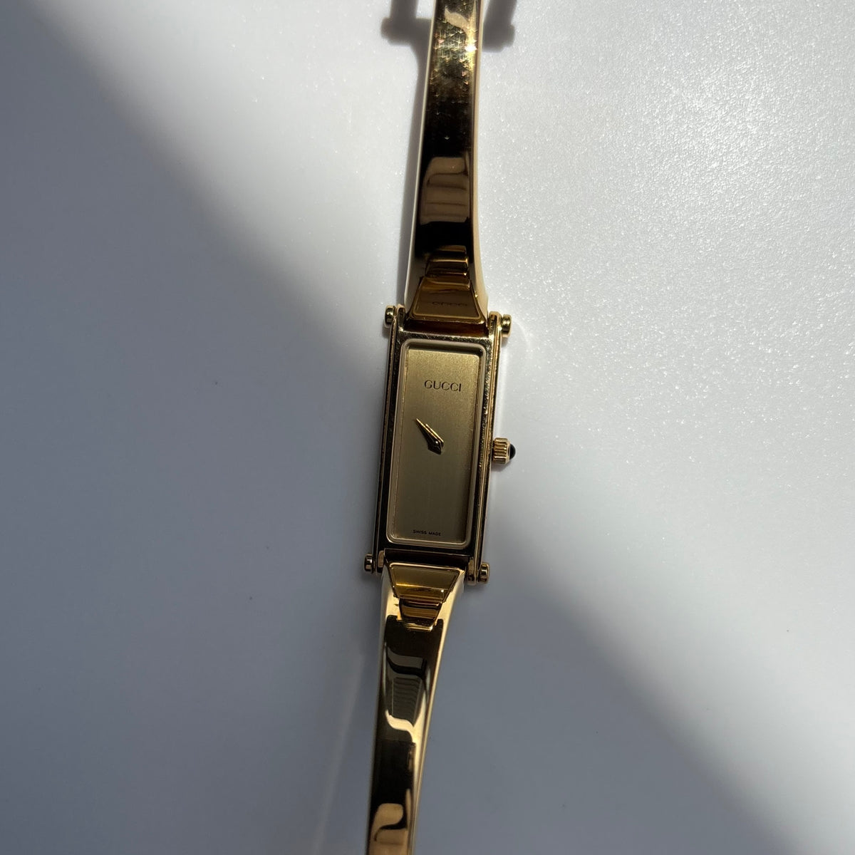 Gucci 1990s Rectangular Gold Dial Gold Plated Bangle Watch