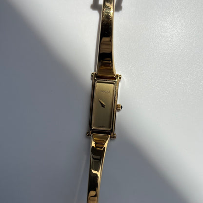 Gucci 1990s Rectangular Gold Dial Gold Plated Bangle Watch