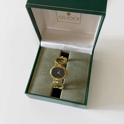 Gucci 1990s Black Dial Oval Gold Plated Bangle Watch