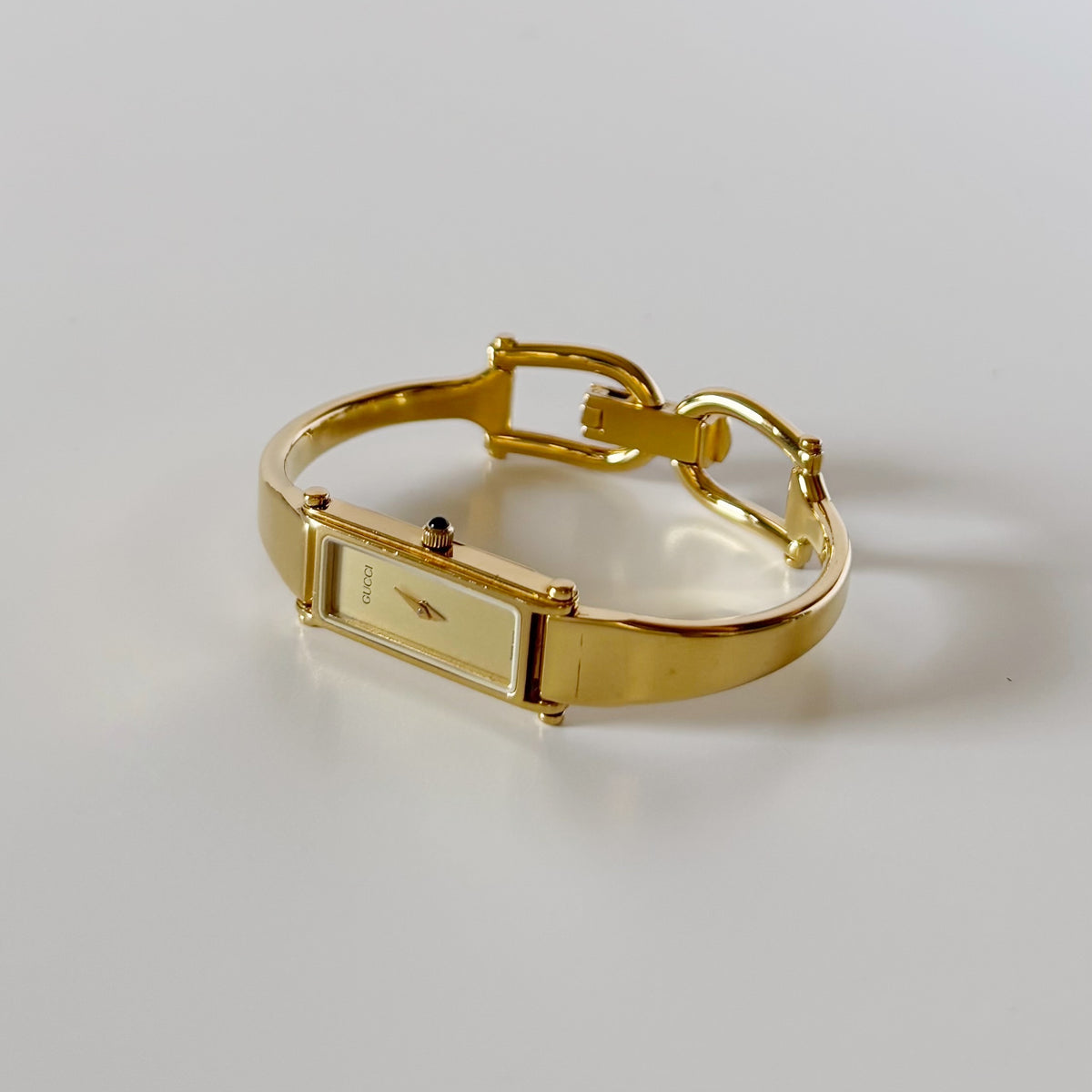 Gucci 1990s Rectangular Gold Dial Gold Plated Bangle Watch