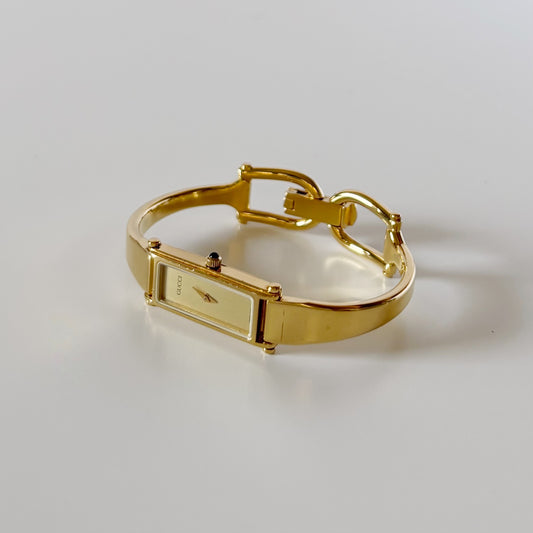 Gucci 1990s Rectangular Gold Dial Gold Plated Bangle Watch